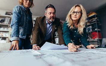 Curry Spa Consulting three people looking at architectural plans